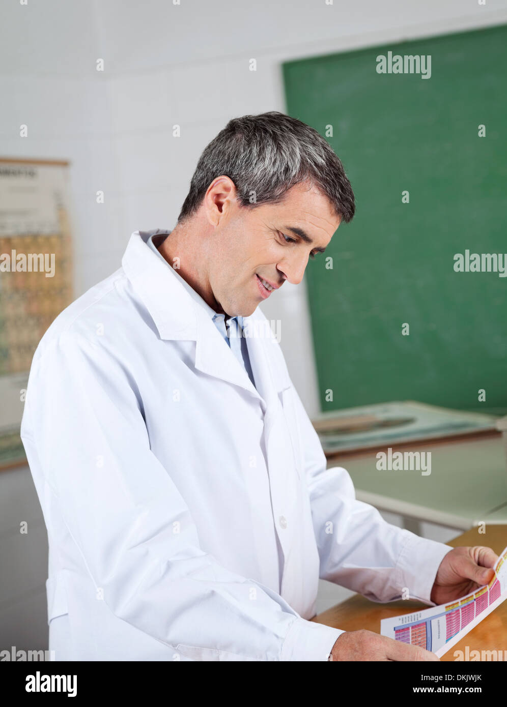 Professor Reading Paper At Desk In Lab Stock Photo - Alamy