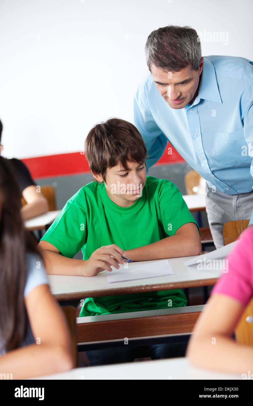 Schoolboy And Professor Looking At Paper During Examination Stock Photo ...