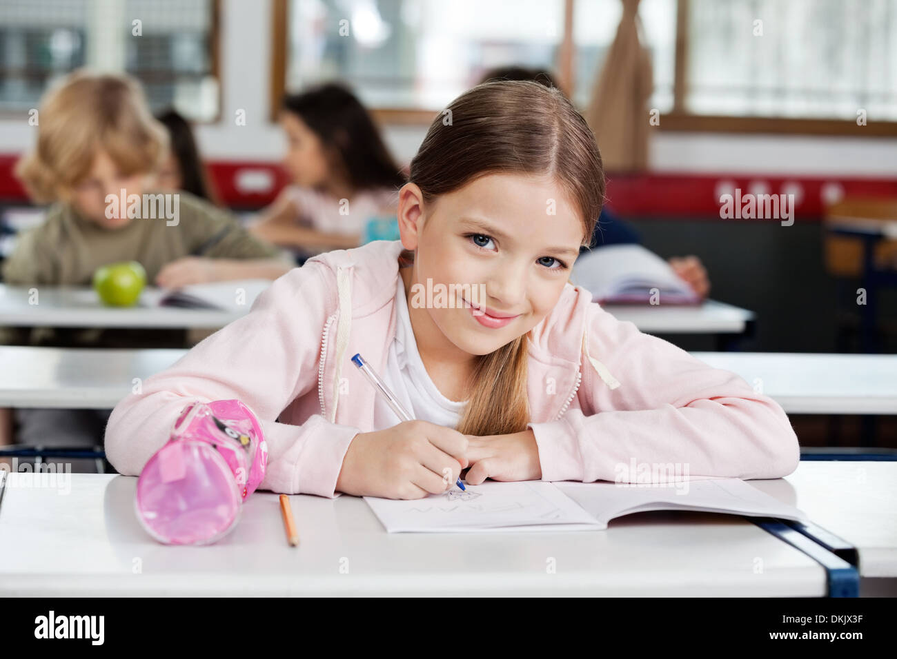 Portrait Of Schoolgirl Drawing In Book Stock Photo - Alamy