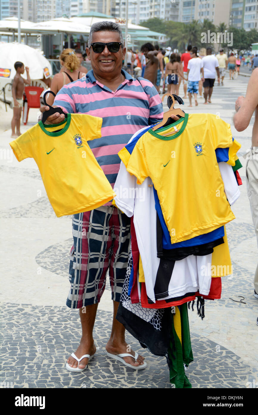 A street hawker with an armful of Brazilian football shirts for sale on  Copacabana beach in Rio de Janeiro, Brazil Stock Photo - Alamy