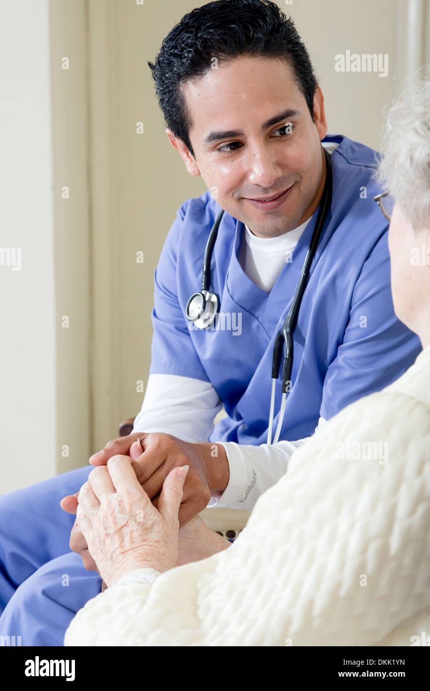 Male nurse assisting elderly patient Stock Photo