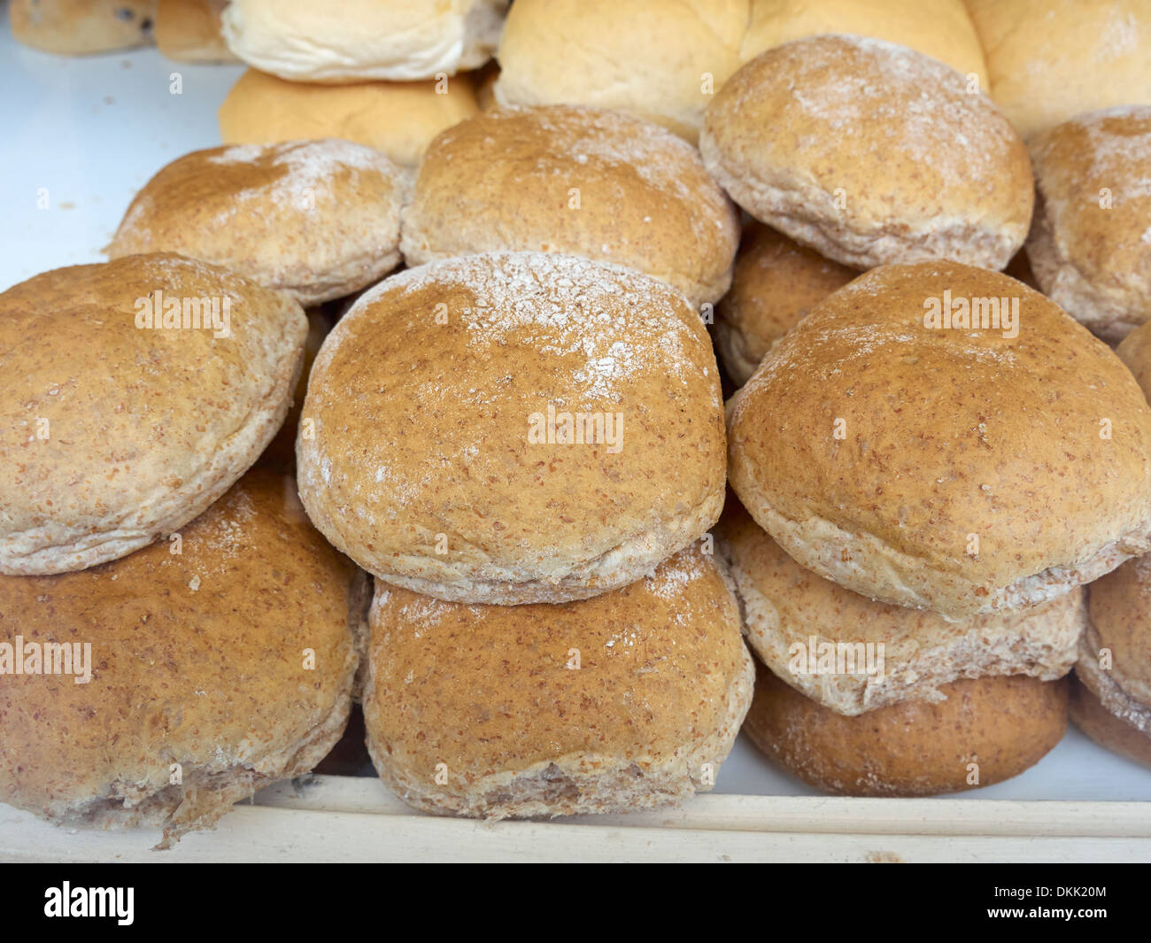 Granary bread rolls in a bakery window Stock Photo