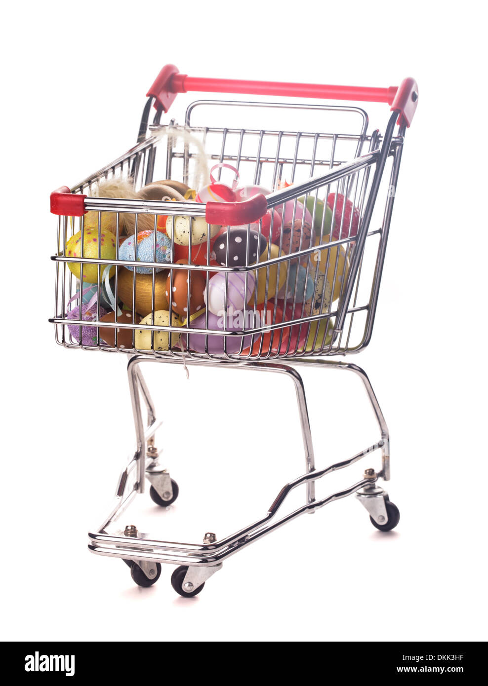 Shopping trolley with many decorative easter eggs on white Stock Photo