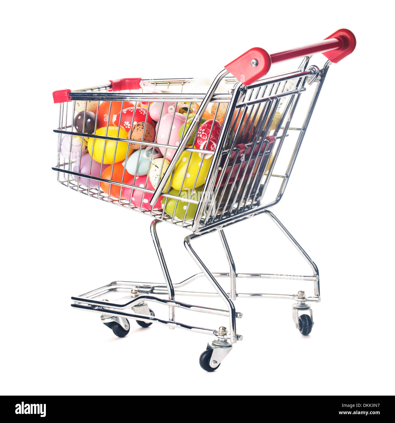 Shopping trolley with many decorative easter eggs on white Stock Photo