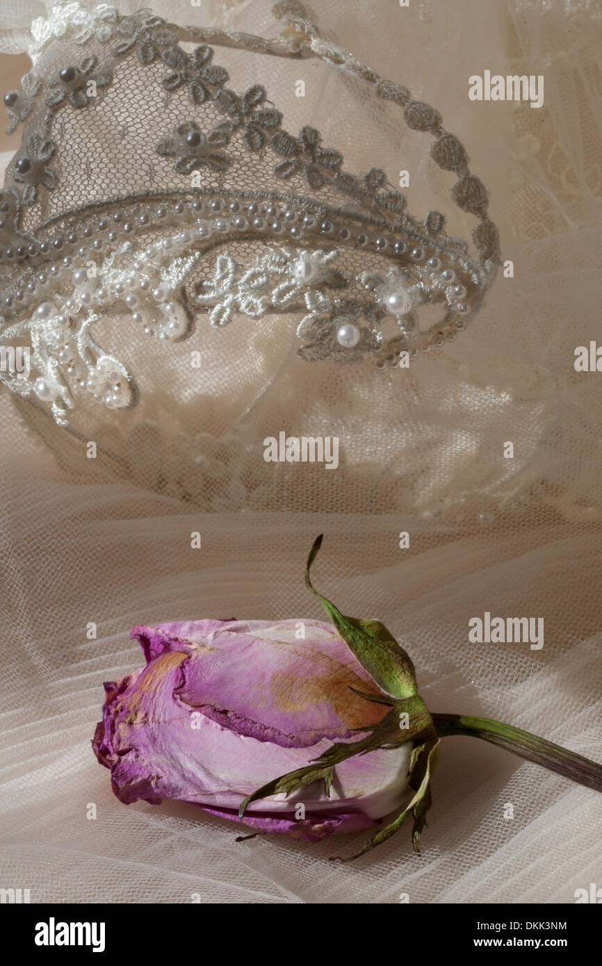 Vintage Wedding Dress, Headpiece and Pressed Rose Still Life Stock Photo