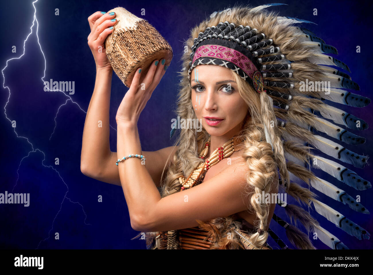 Beautiful woman in native American headpiece with drums Stock Photo