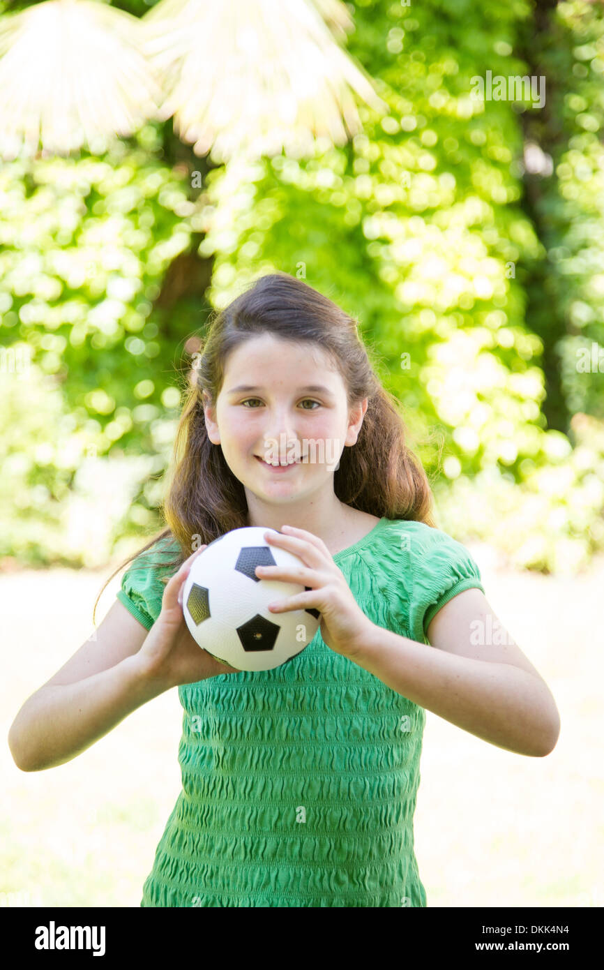 Young girl holding soccer ball Stock Photo Alamy