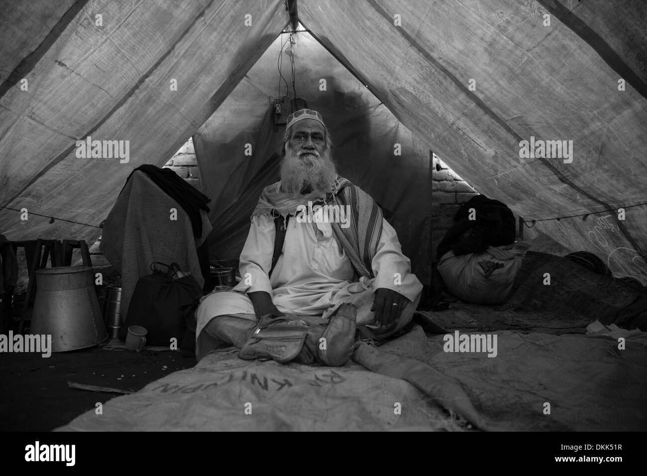 Rangpur, Bangladesh. 21st Feb, 2013. A Bihari elder sits in his makeshift tent as his home has been burnt down in an arson attack.42 years after the 1971 war there are still an estimated 600,000 Biharis (also known as 'stranded Pakistanis') living in Bangladesh. © Hanna Adcock/ZUMA Wire/ZUMAPRESS.com/Alamy Live News Stock Photo