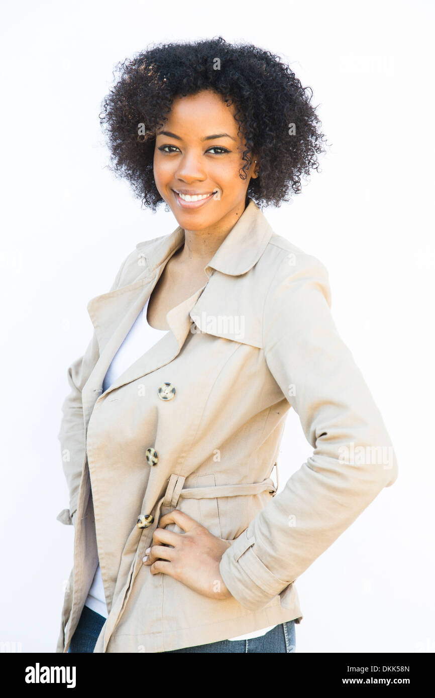 Smiling African American woman standing against white background Stock Photo