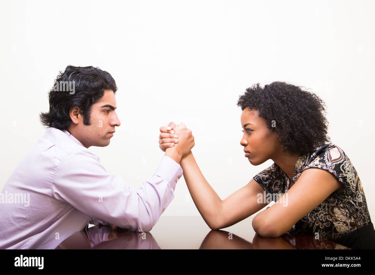 Young Indian business man wrestling with a client Stock Photo