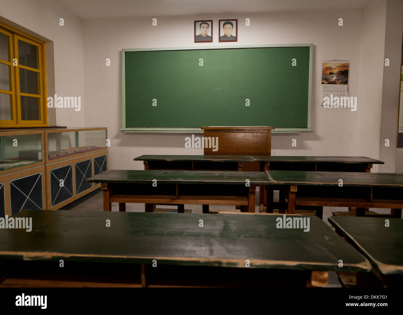 Mock-up of North Korean school classroom displaying portraits of Kim Il Sung and Kim Jong Il above blackboard Stock Photo