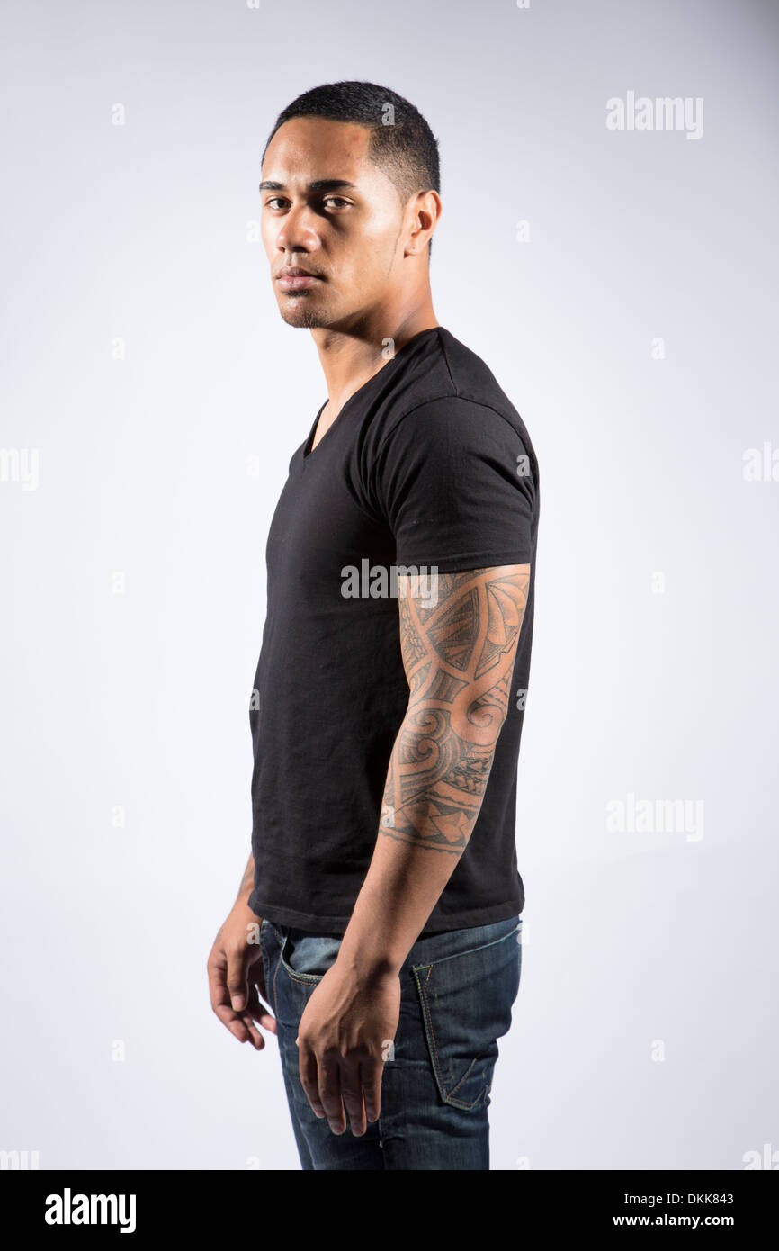 Young tattooed man posing on white background Stock Photo