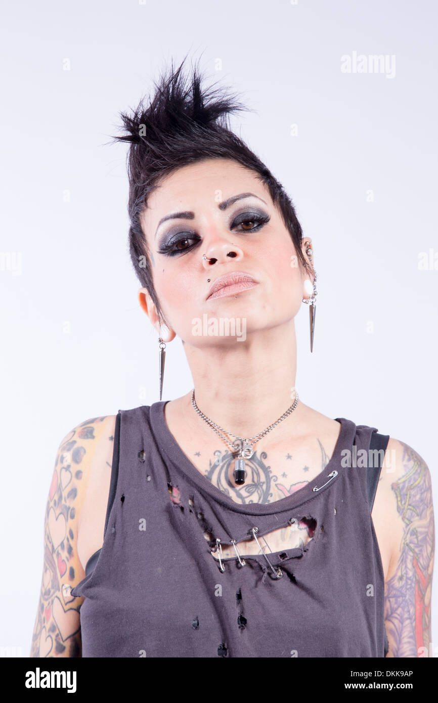 Tattooed punk girl posing on white background Stock Photo - Alamy