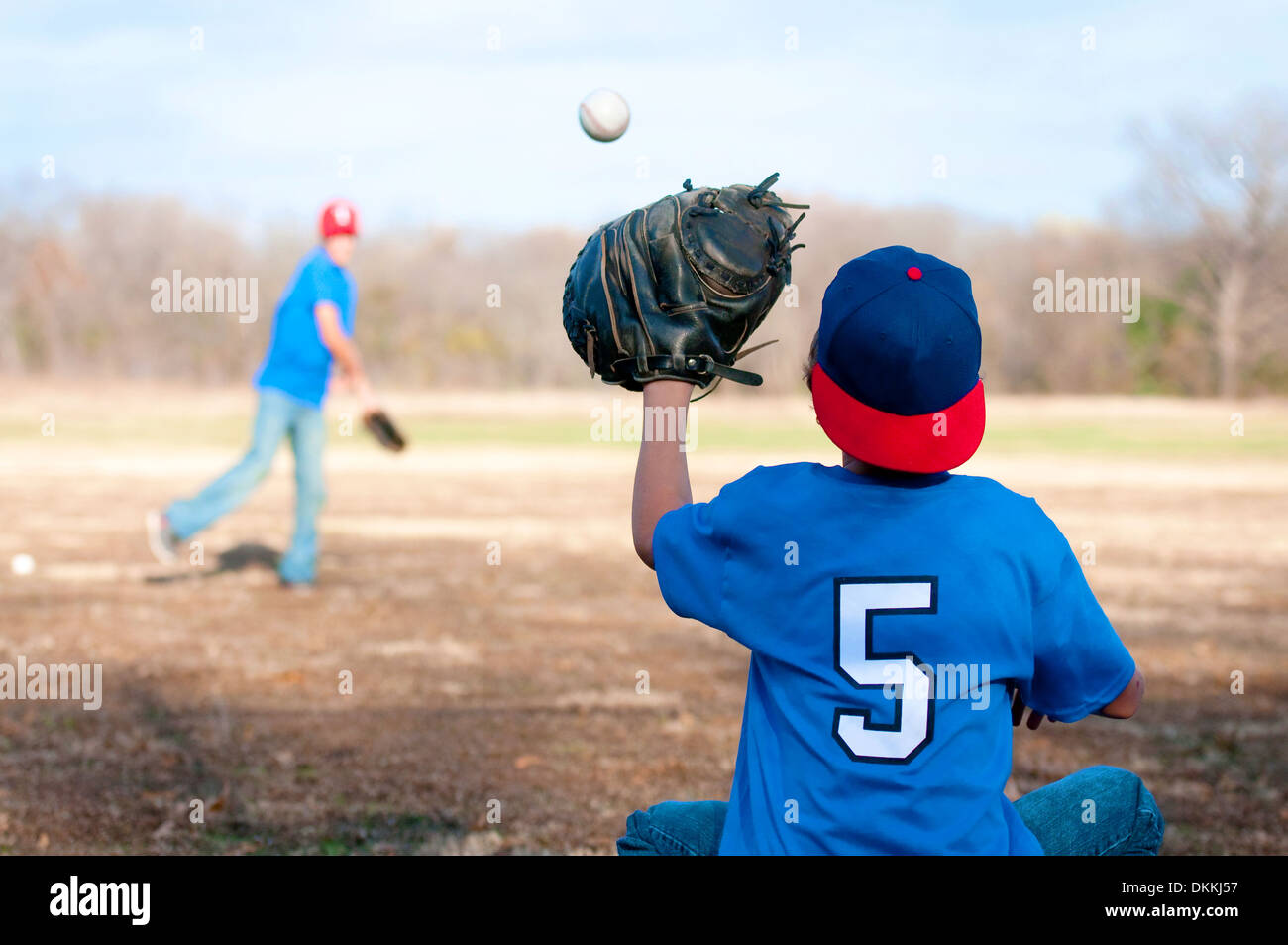 Two boys playing catch at a park. Stock Photo