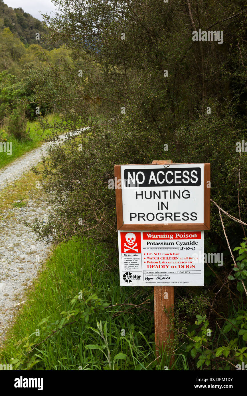 Hunting and Possum poisoning sign on roadway on a rural New Zealand  South Island farm Stock Photo