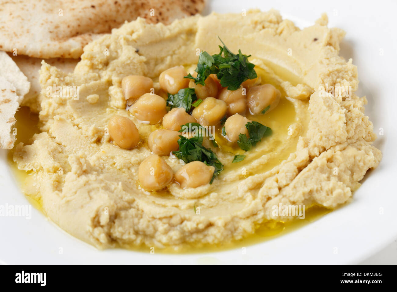 Arab masbacha, hummus dip served with whole chickpeas and a chilli and lemon flavoured sauce and unleavened bread. Stock Photo