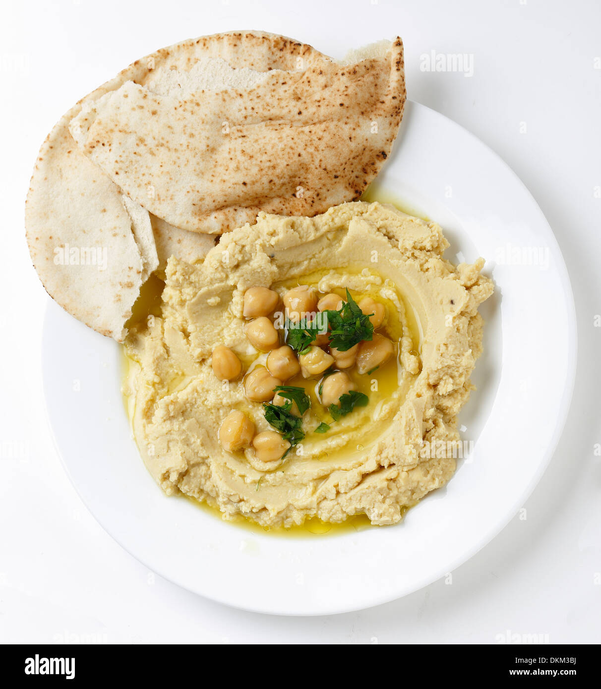 Arab masbacha, hummus dip served with whole chickpeas and a chilli and lemon flavoured sauce and unleavened bread. Stock Photo