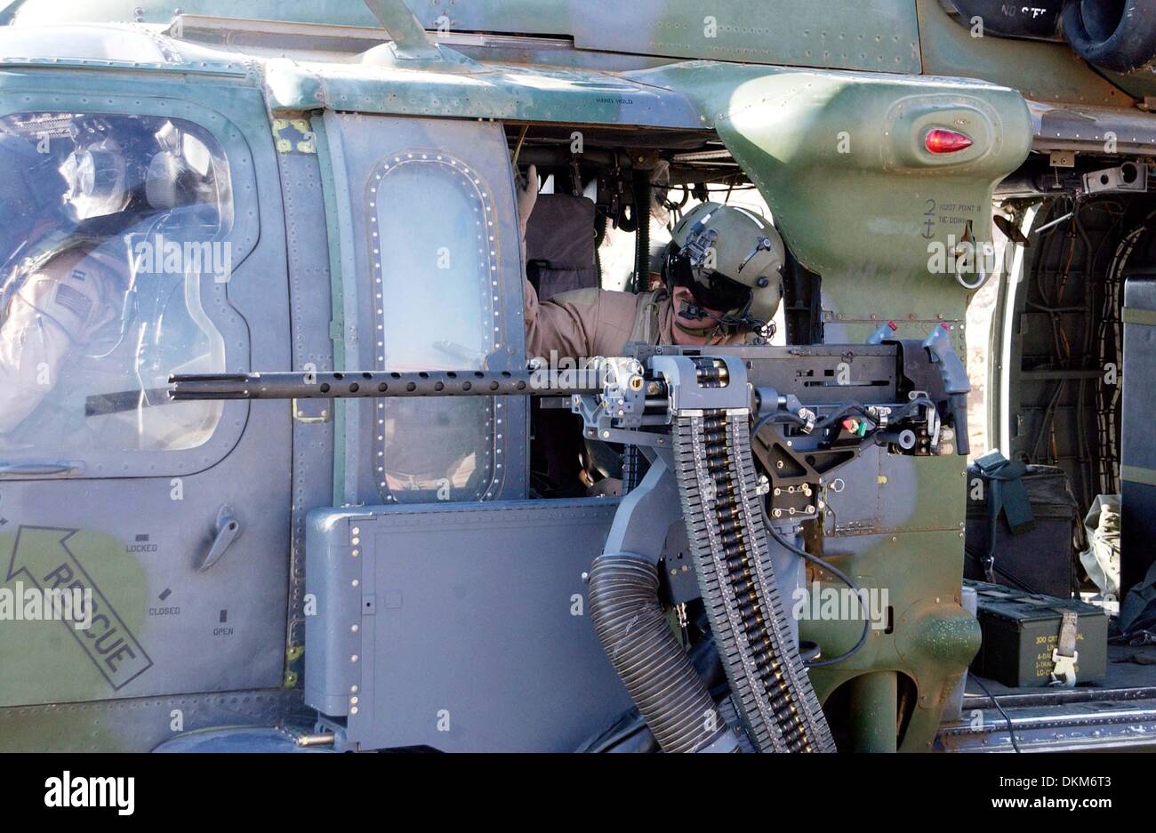 Nov. 23, 2002 - A member of the 66th Expeditionary Rescue Squadron is checking over the 50 caliber machine gun before a flight. The 66th had just completed a Time Compliance weapon modifications on an HH-60 Pavehawk helicopter. Forward deployed, the 410 Air Expeditionary Wing, is responsible for combat search and rescue sorties flown in support of Operation Iraqi Freedom. Operation Stock Photo