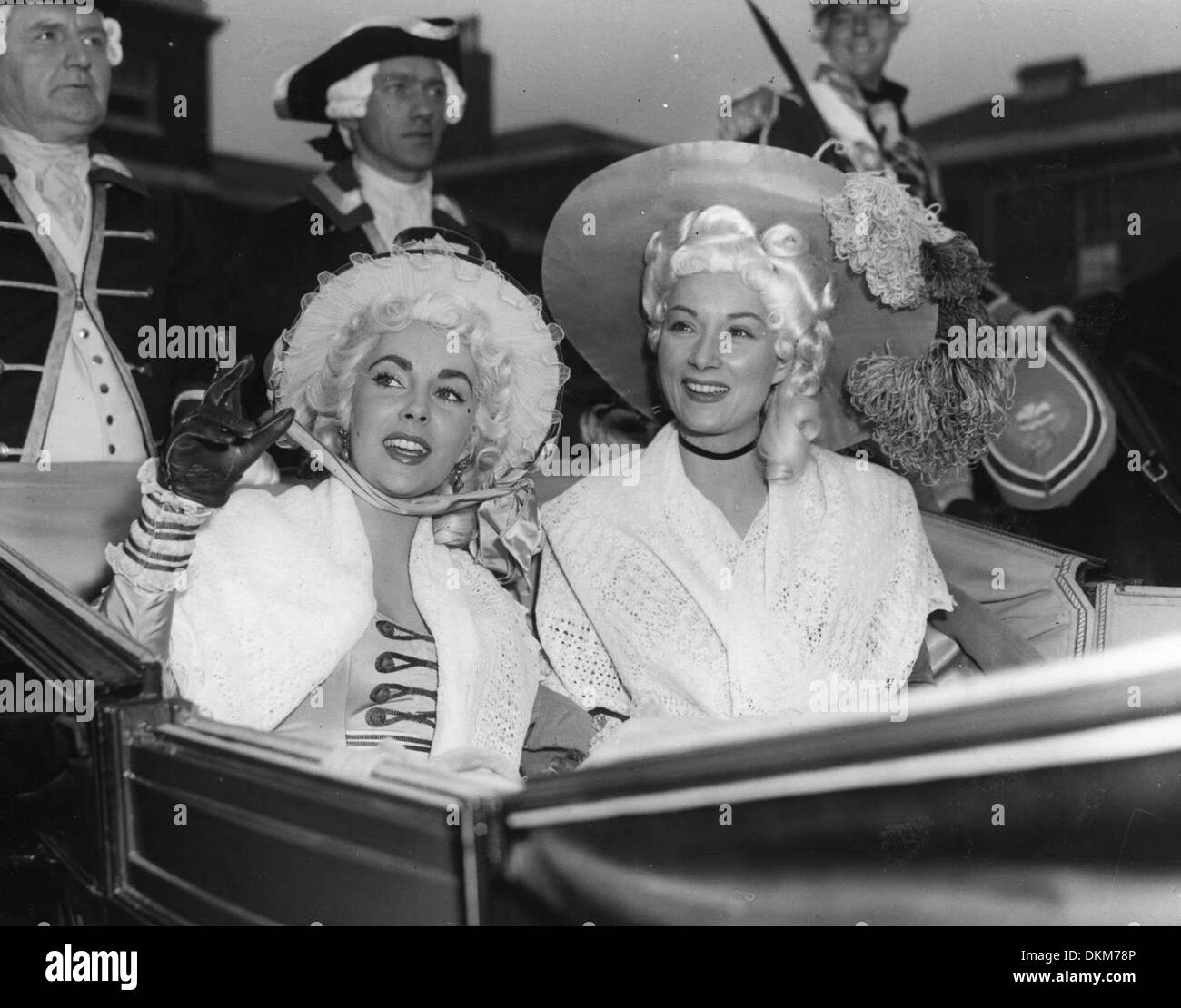 Dec. 12, 1953 - London, England, U.K. - Academy Award winning film legend, ELIZABETH TAYLOR will be starring as 'Lady Patricia' in the MGM film, 'Beau Brummel.' PICTURED: Liz Taylor and co-star ROSEMARY HARRIS ride in a carriage through the Woolwich Barracks during the film. (Credit Image: © KEYSTONE Pictures USA) Stock Photo