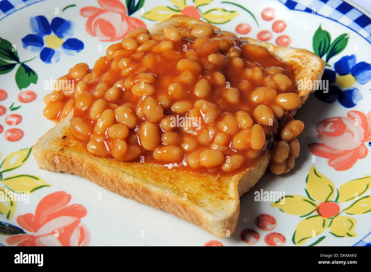 One round of baked beans on toast in tomato sauce. Stock Photo