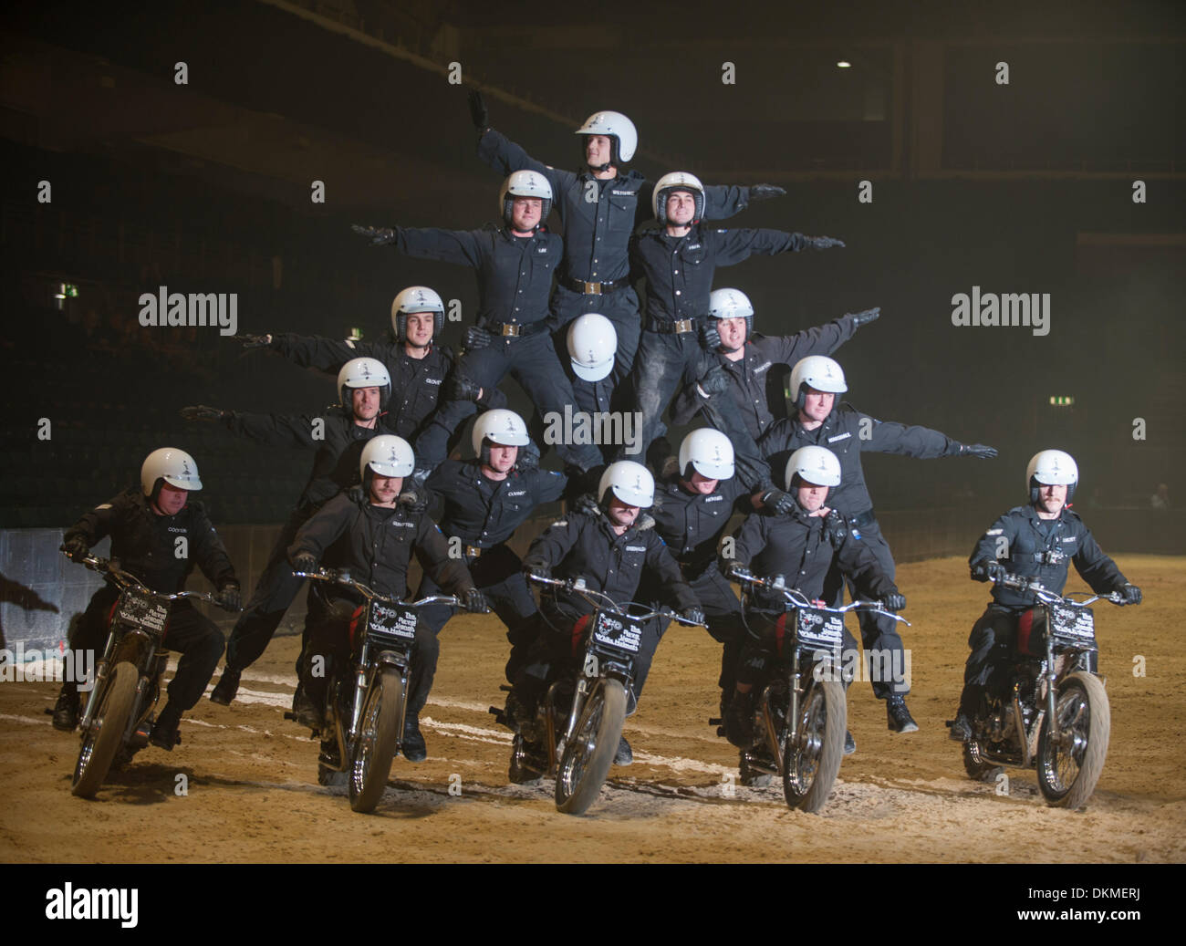 Earls Court, London UK. 6th Dec, 2013. The British Military Tournament rehearsal takes place, one of the largest displays of military theatre in the world. The Royal Signals’ White Helmets team form a human pyramid on motorcycles. The tournament raises much needed funds to support the brave men and women of the British Armed Forces as well as their families. Credit:  Malcolm Park editorial/Alamy Live News Stock Photo