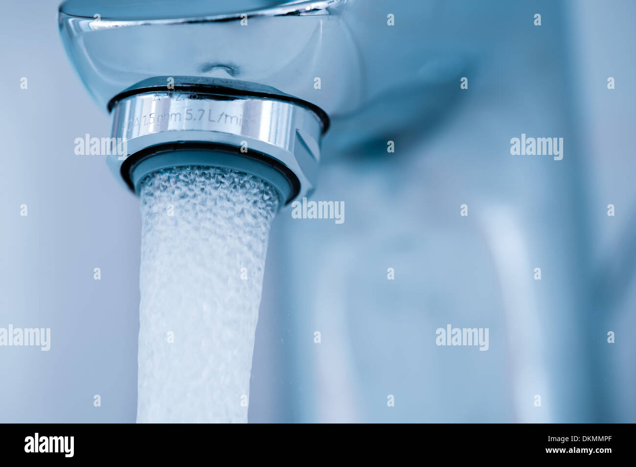 Tap closeup with leaking water stream. Stock Photo