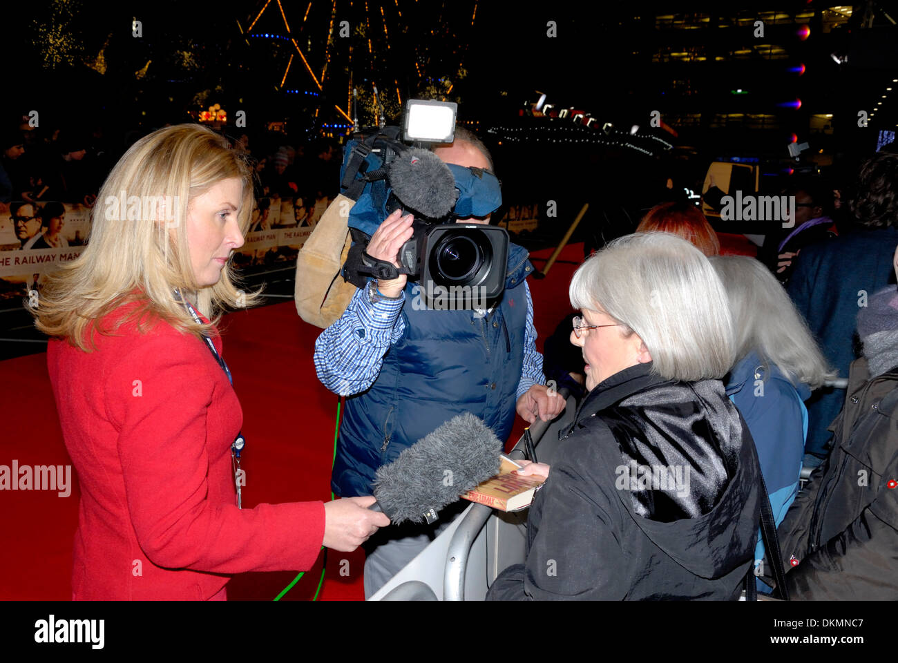 Waiting fans being interviewed by Emma Jones, BBC entertainment correspondent on the red carpet at film premiere Stock Photo