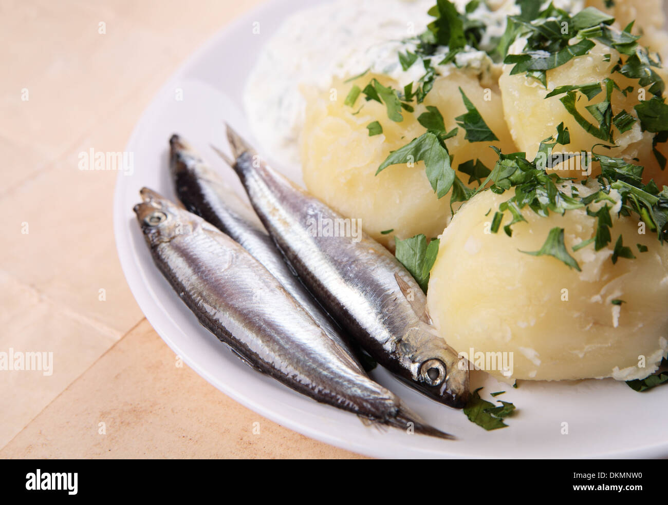 Boiled potatoes with salted fish Stock Photo