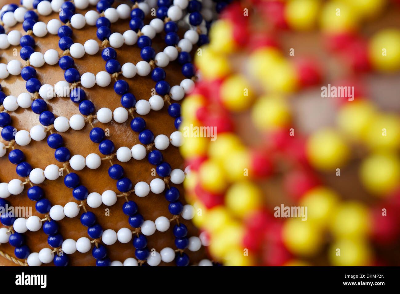 Afro Brazilian shekere beaded gourd shaker drum close-up with colorful beads Stock Photo