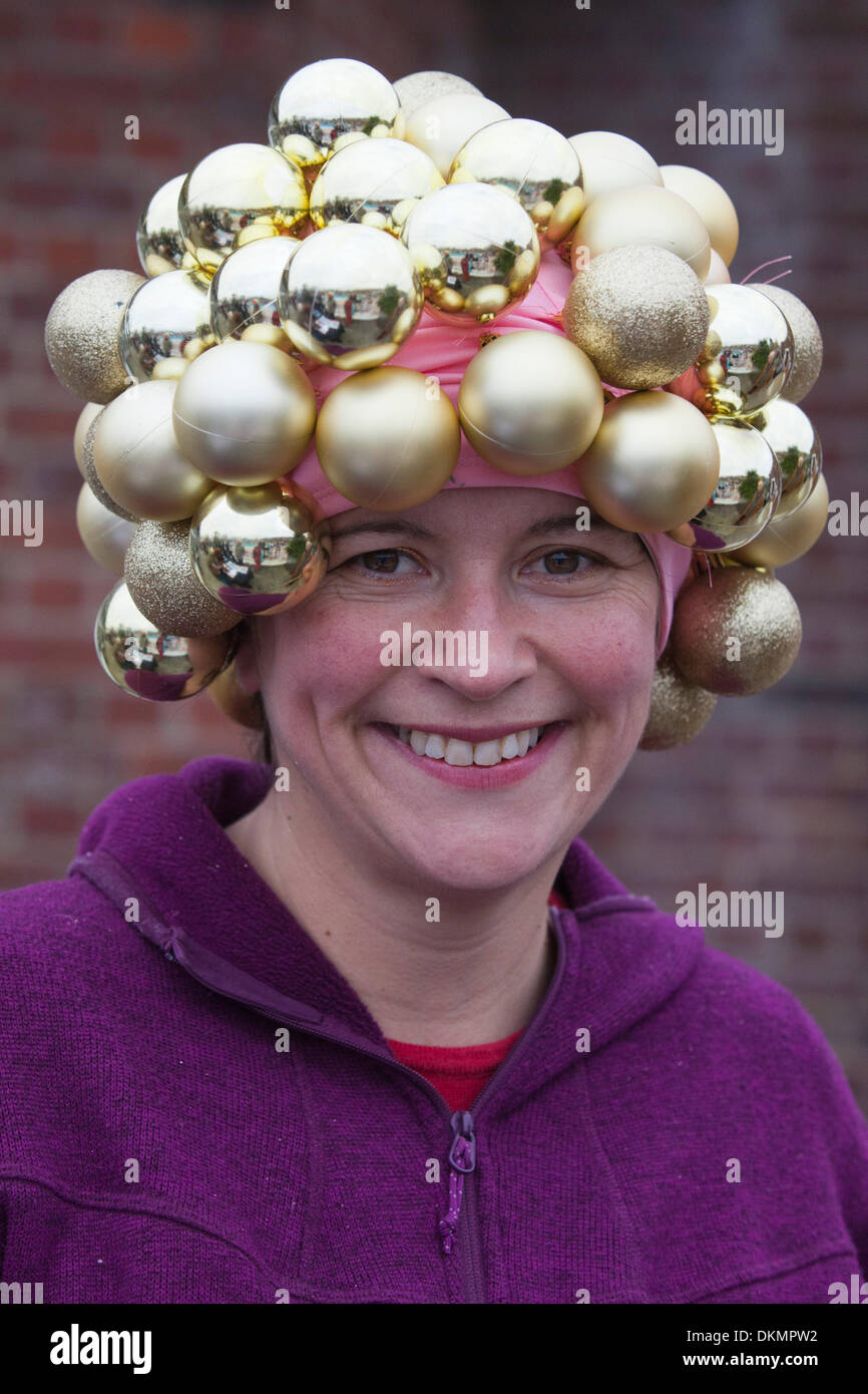 London UK. 7 December 2013. Woman with a bauble hat. Several hundred brave swimmers many in seasonal fancy dress braced the cold water temperature 6 C air temperature 9 C and took a plunge at