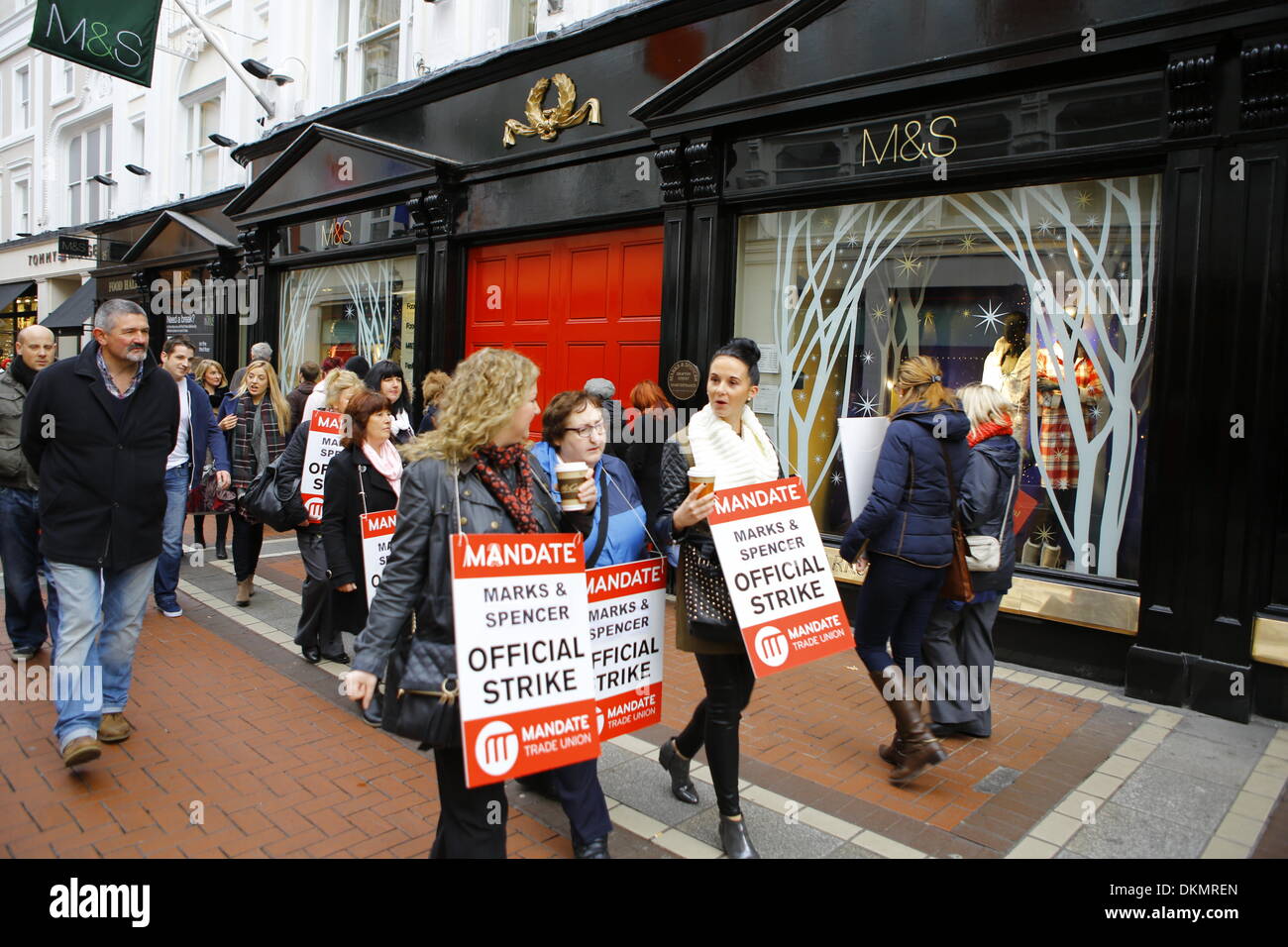 Dublin, Ireland. 7th December 2013. Striking Marks & Spencer employees picket the Grafton Street store in Dublin. Over 2000 Marks & Spencer employee from the MANDATE Trade Union went on their first of 3 strike days, closing all 17 Irish M & S stores. The strike is over the unilateral closing of the defined pension benefit scheme by Marks & Spencer in October. Credit:  Michael Debets/Alamy Live News Stock Photo