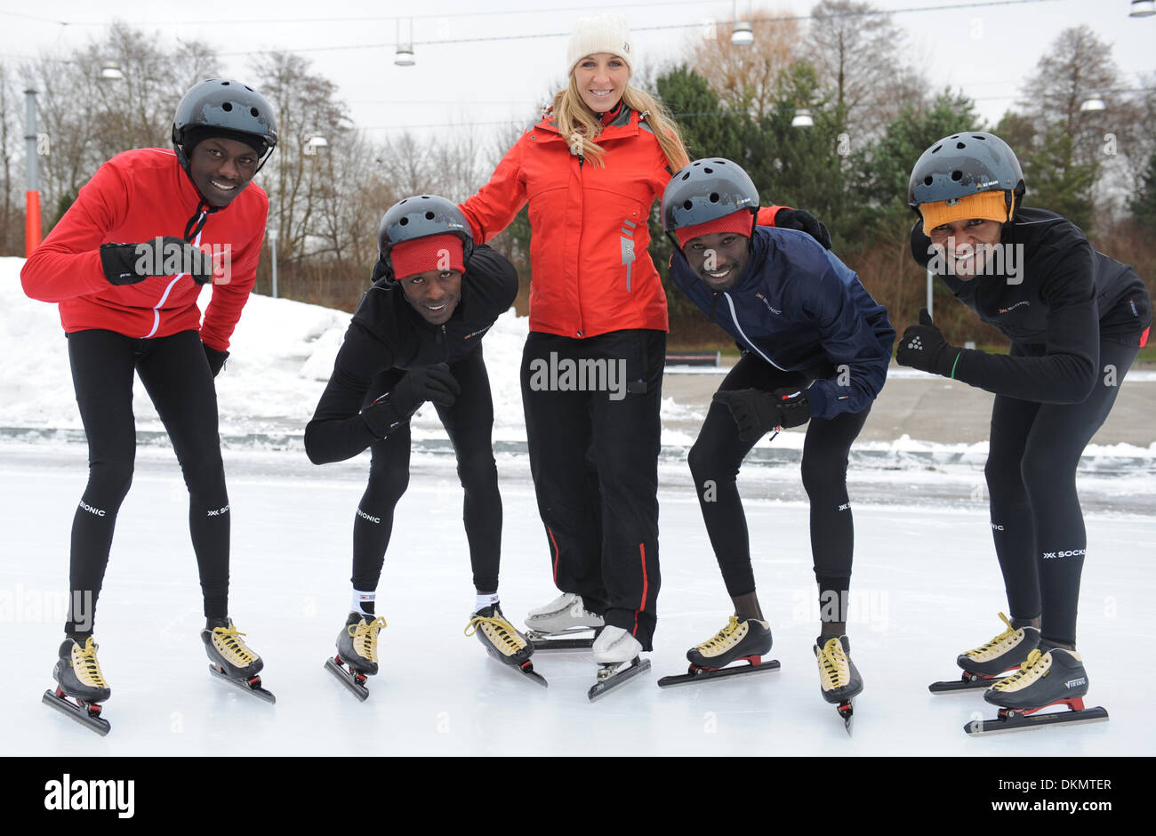 Munich, Germany. 07th Dec, 2013. Olympic speed skating gold medalist Anni Friesinger-Postma poses with Kenya's Amos (L-R), Isaac, Samy und Leonard at the speed skating rink in Munich, Germany, 07 December 2013. They are preparing for the 100km speed skating marathon at the end of January 2014 under the motto 'Real Cool Runnings. From Kenya on the Ice.' The young men from Eldoret are actually athletics athletes and have never been on the ice before. The project can be followed on television channel VOX every Tuesday at 8:15 pm. Photo: ANDREAS GEBERT/dpa/Alamy Live News Stock Photo
