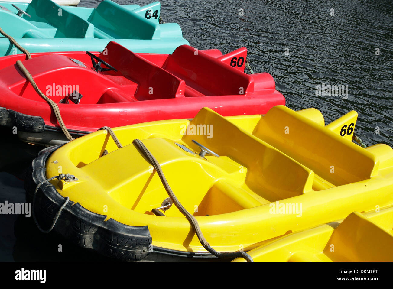 Brightly coloured pedal boats moored on the River Dee at Chester, Cheshire. Stock Photo