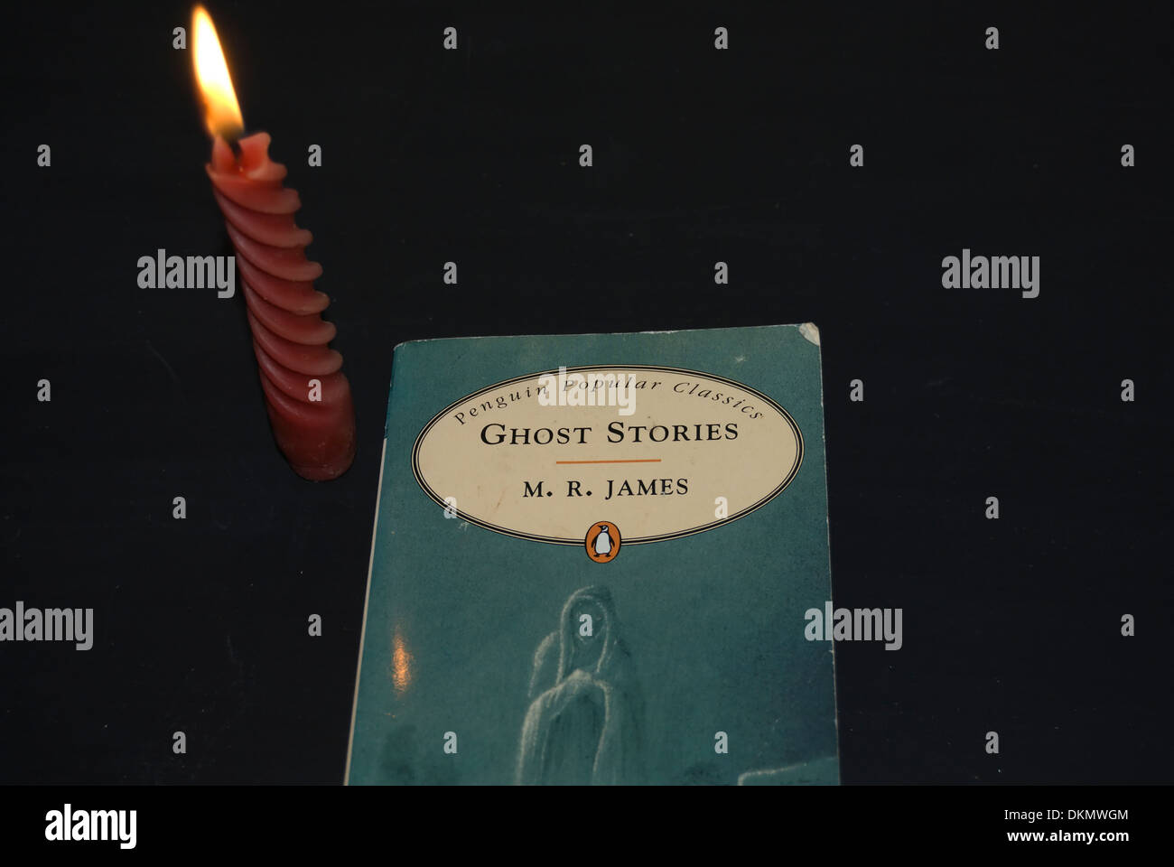 book of ghost stories by author m.r.james, with candle Stock Photo