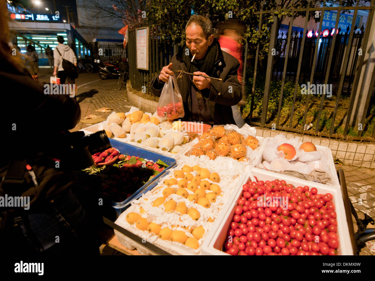 Old man selling fruits on street in Shanghai, China Stock Photo