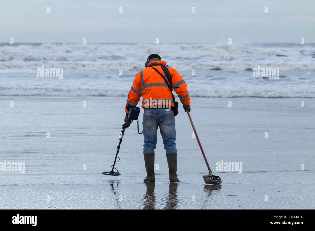 Man metal detecting with metal detector on beach. UK Stock Photo Alamy