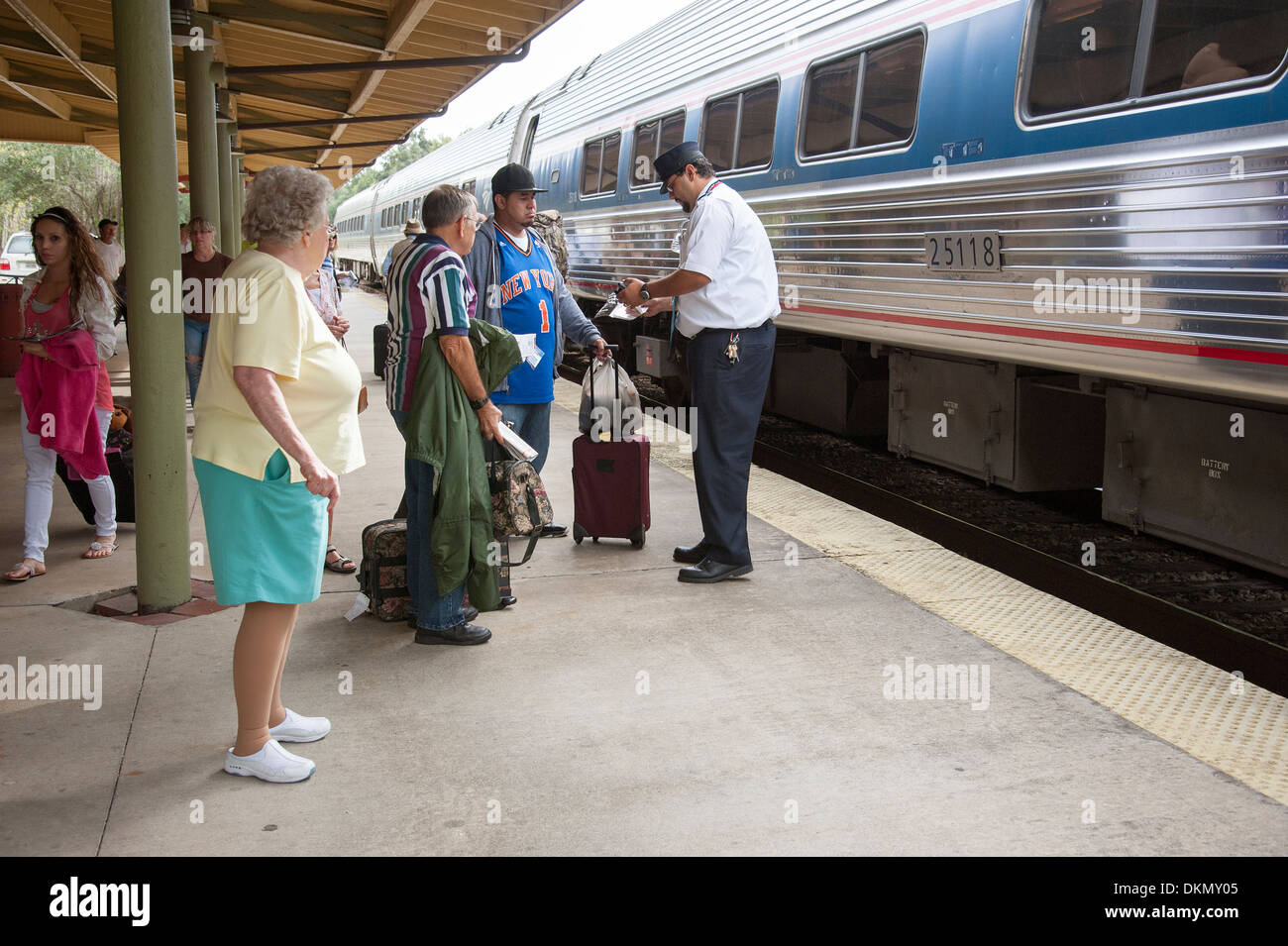 Railroad train passengers board and alight Conductor checking tickets Stock Photo