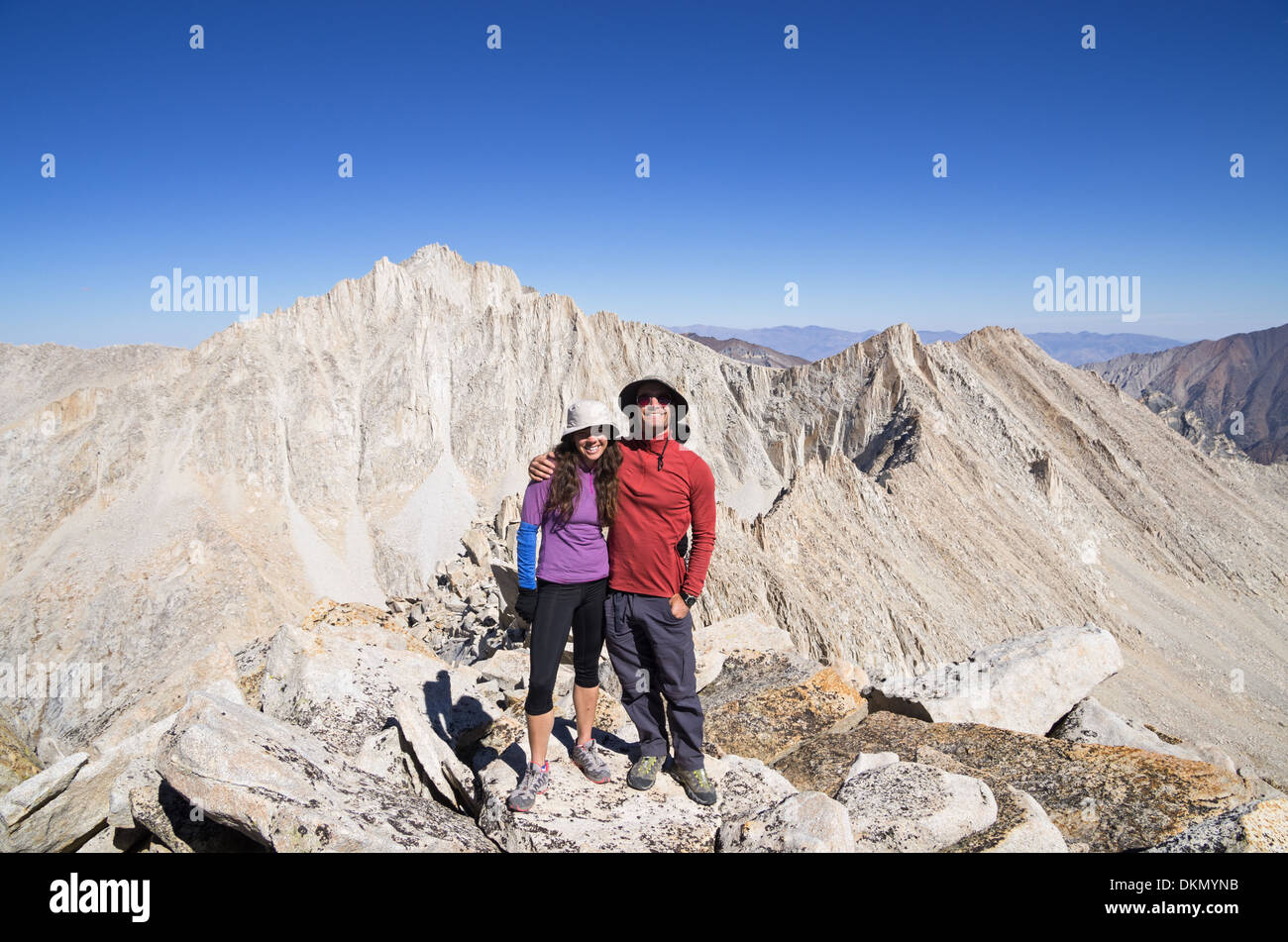 smiling couple on top of Mount Julius Caesar in the Sierra Nevada mountains Stock Photo