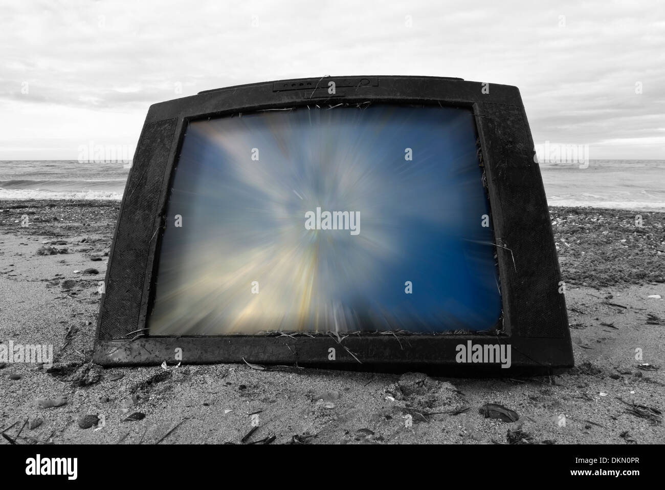 Television set washed up on a beach. Stock Photo
