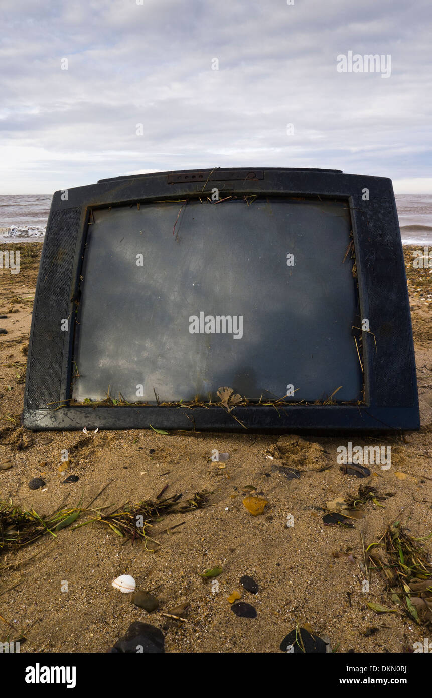 Television set washed up on a beach. Stock Photo