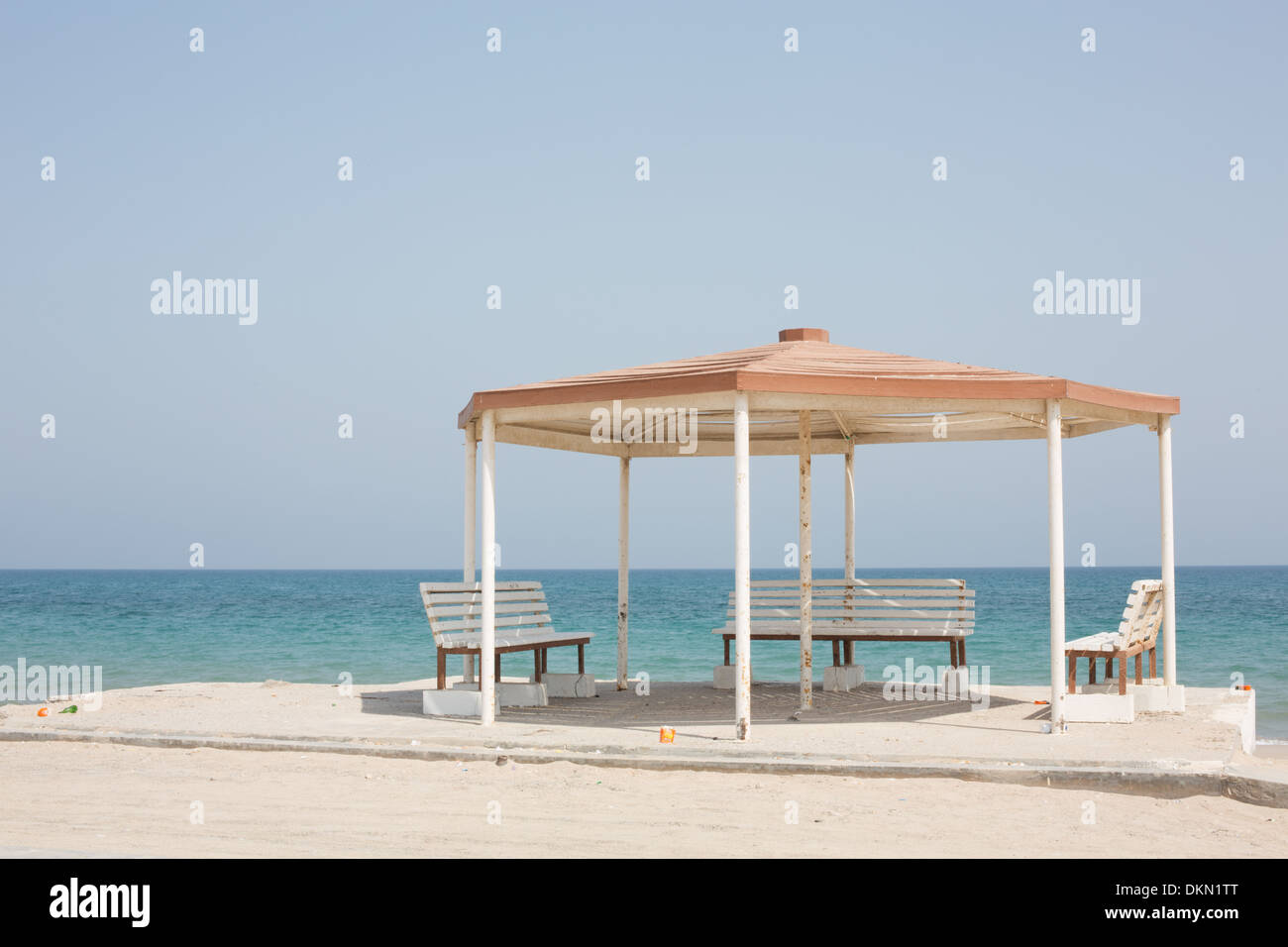 A metal gazebo with benches with seas of the Straits of Hormuz in the background, Dibba, Oman Stock Photo