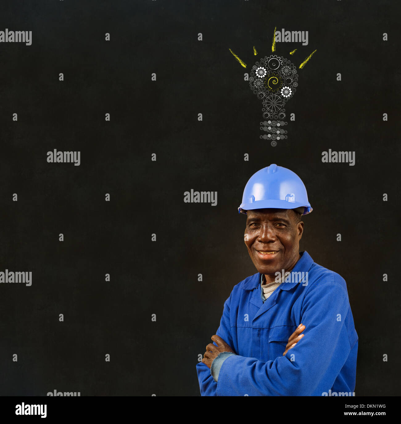 African American black man worker with a chalk gear cog lightbulb on a blackboard background Stock Photo