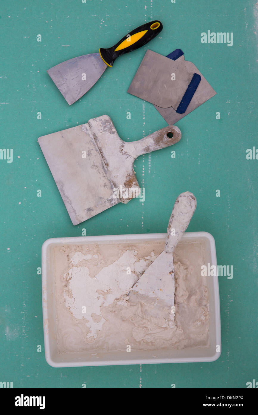 Platering tools for plaster like plaste trowel spatula on green drywall plasterboard Stock Photo