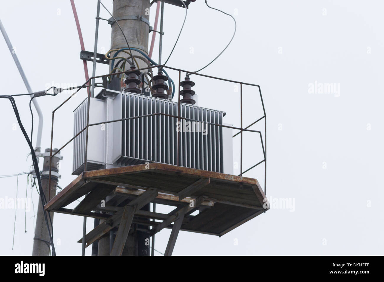 Electrical Power Transformer on an electricity pylon in winter Stock Photo
