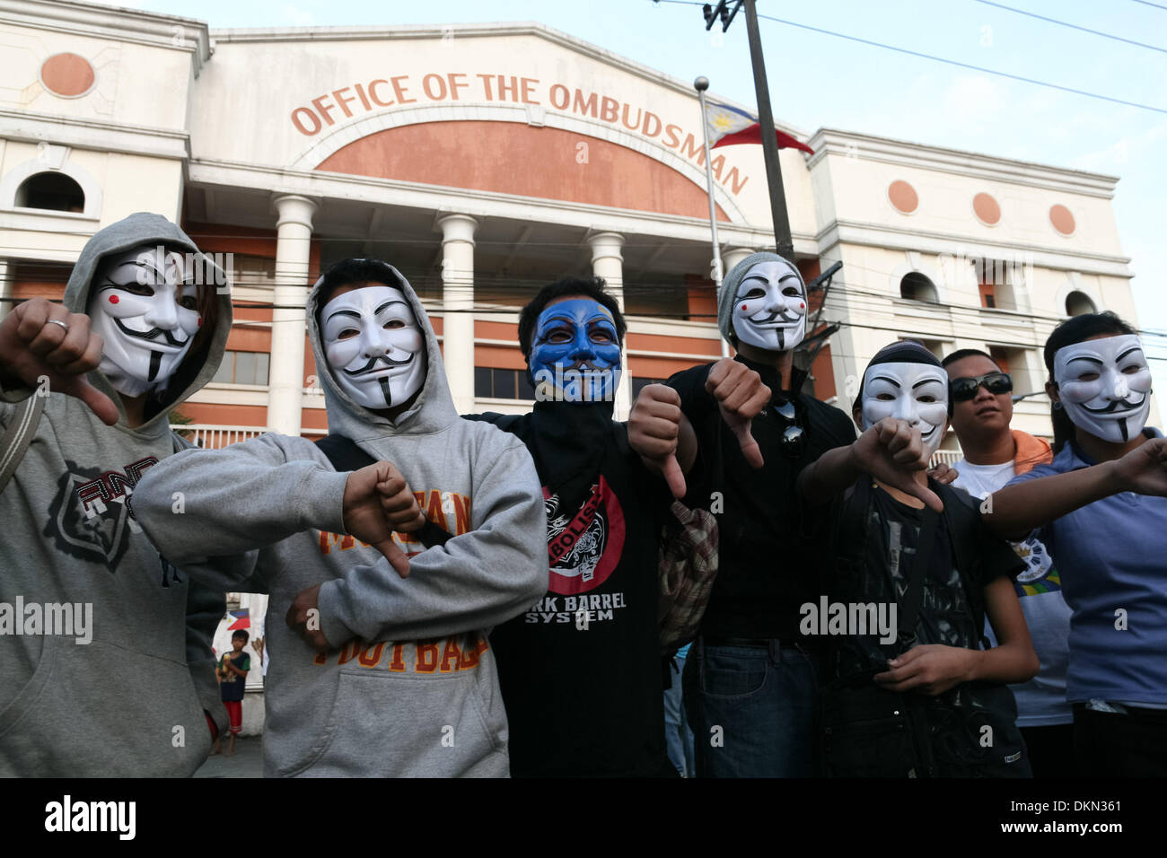 Manila, Philippines. 6th Dec, 2013. Anonymous Philippines members give thumb downs in front of the Office of the Ombudsman in Quezon City.Photo: J Gerard Seguia/NurPhoto Credit:  J Gerard Seguia/NurPhoto/ZUMAPRESS.com/Alamy Live News Stock Photo