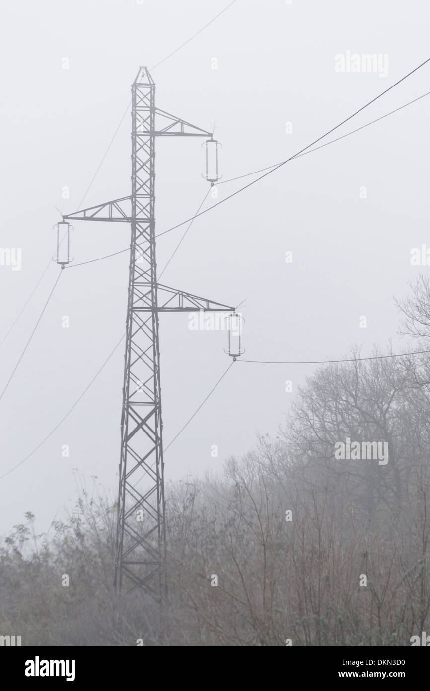 Road with electricity pylons in the background in winter Stock Photo ...