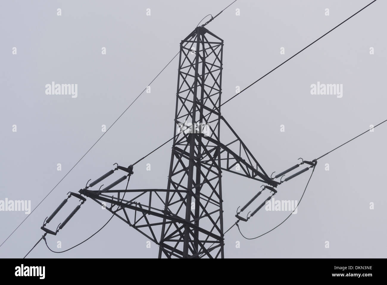 Electricity pylon with mist in the background in winter Stock Photo - Alamy