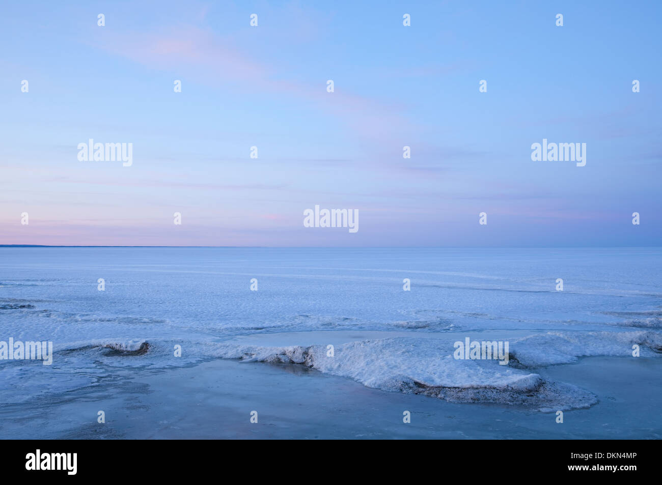 An evolving landscape of thawing and shifting ice graces Lake Simcoe in the early spring warmth. Georgina, Ontario, Canada. Stock Photo