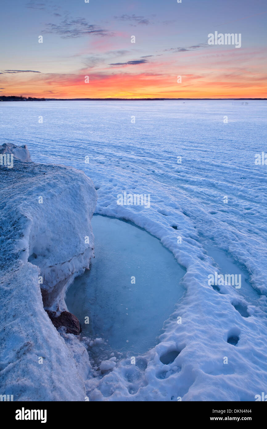 An evolving landscape of thawing and shifting ice graces Lake Simcoe in the early spring warmth. Georgina, Ontario, Canada. Stock Photo