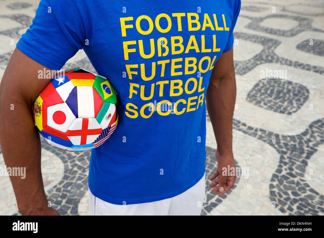 Brazilian soccer player wears international football shirt carrying a ball with World Cup team flags Stock Photo